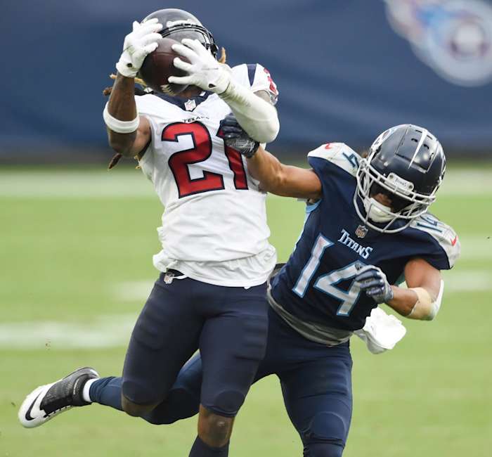 Houston Texans cornerback Bradley Roby (21) pulls in an interception of a pass intended for Titans receiver Kalif Raymond (14) George Walker IV/ Tennessean.com via Imagn Content Services, LLC